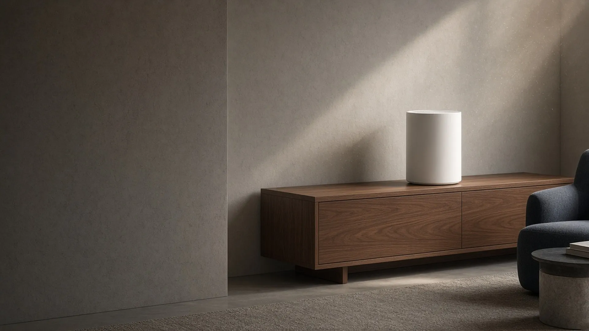A plain air purifier on a console in a sunlit sitting room