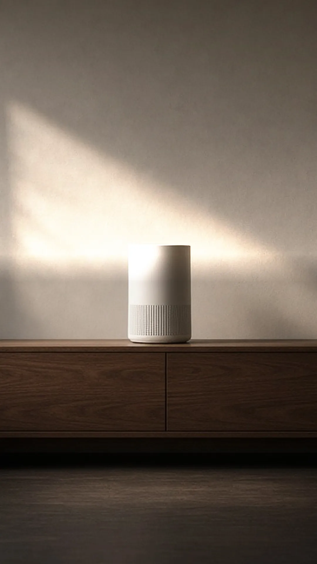 A plain air purifier on a console in a sunlit sitting room