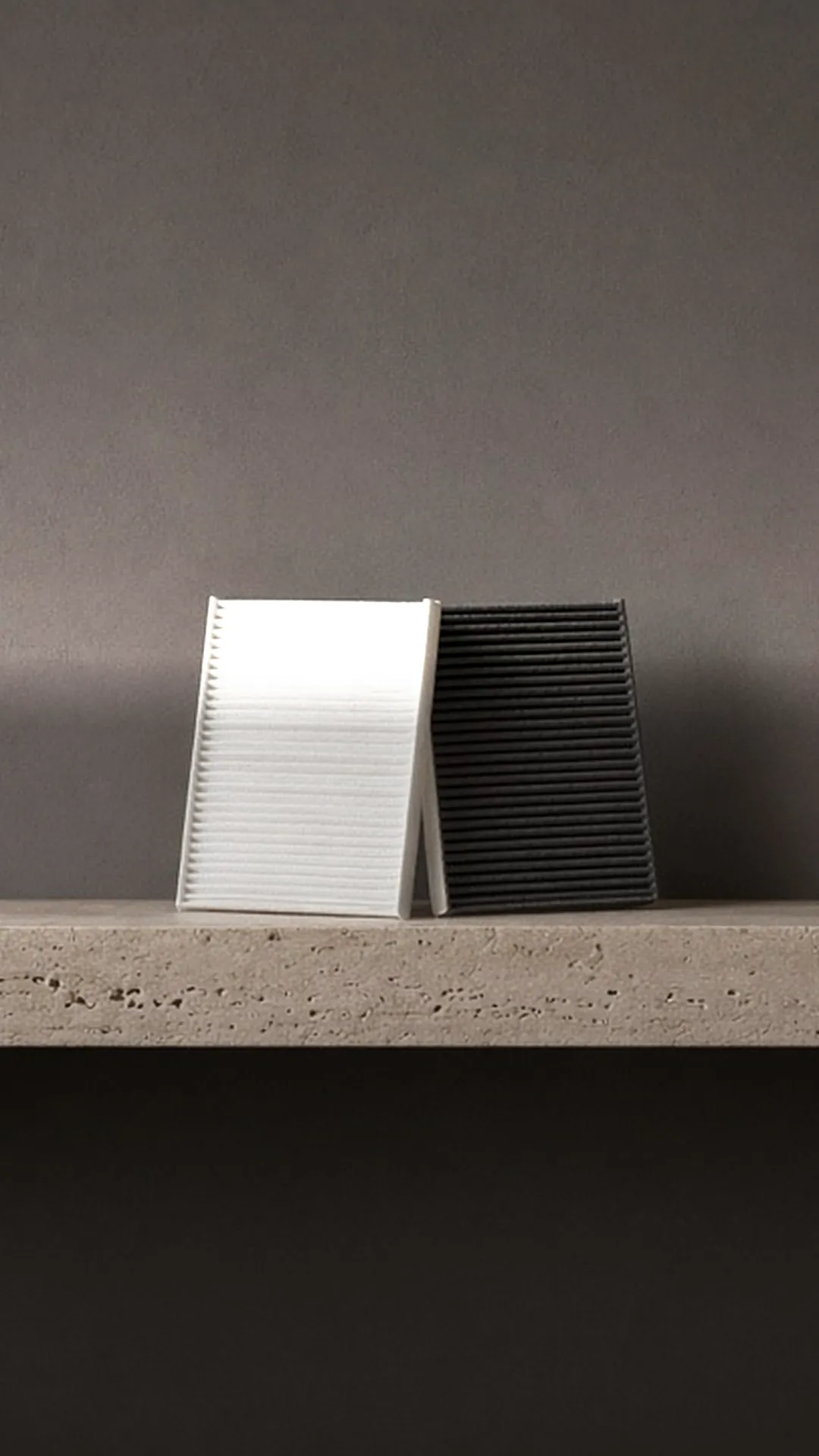 A pleated filter and a carbon filter on a stone plinth